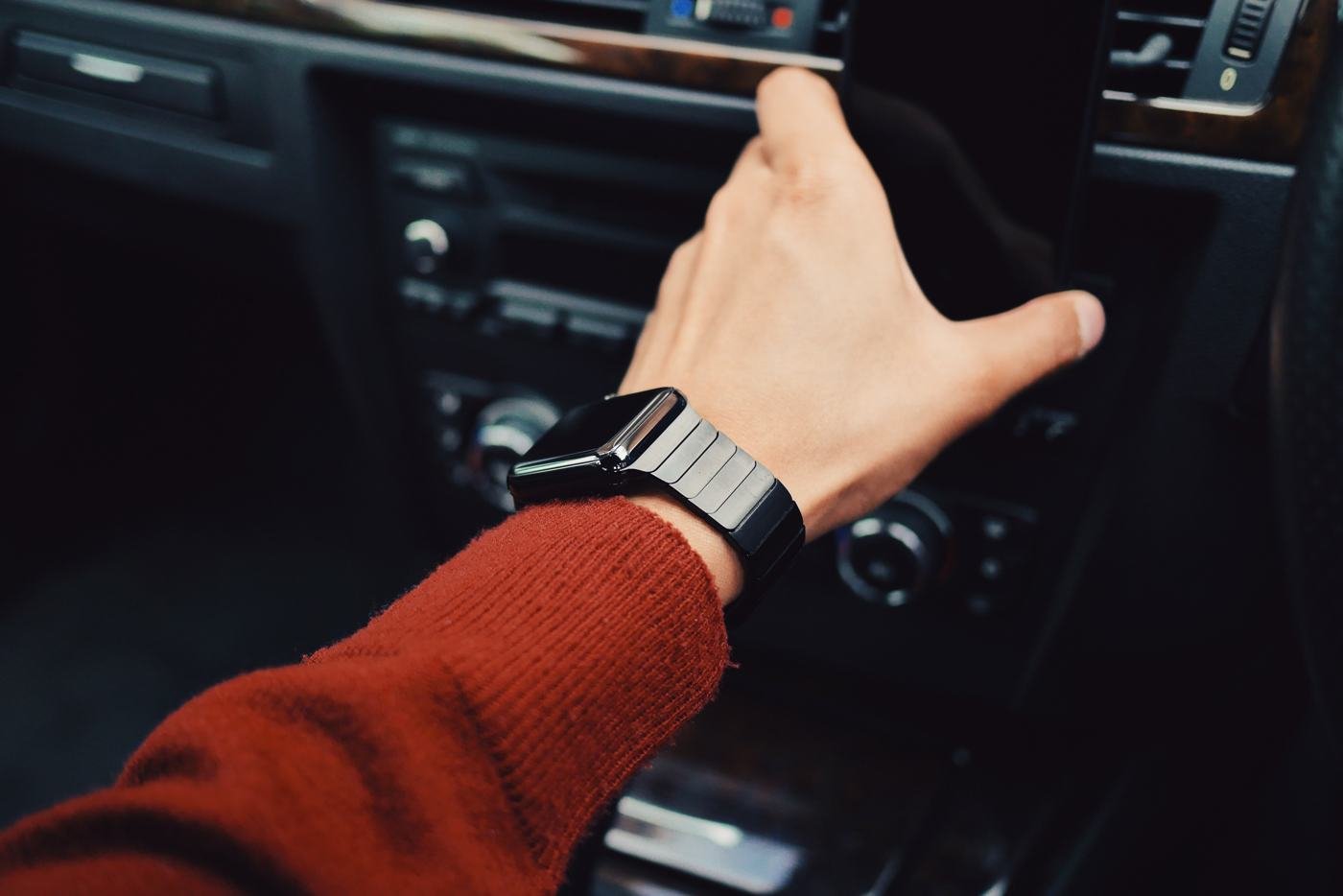 A hand on the gear stick inside a car